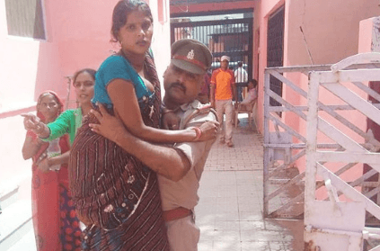 policeman carries pregnant woman to hospital in arms