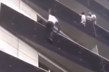 Real life 'spider man' climbs building to save dangling boy