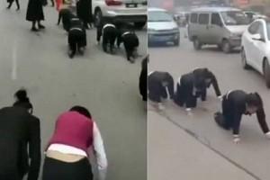 Employees forced to crawl on road for failing to meet targets