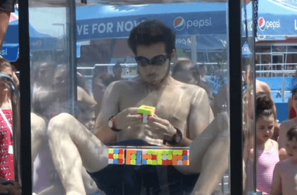 teen solves six rubik\'s cubes underwater