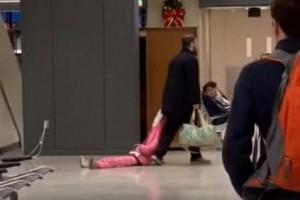 Watch - Father frustrated with daughter drags her through airport