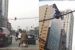 Watch - Man walks over power cables to cross road due to heavy traffic